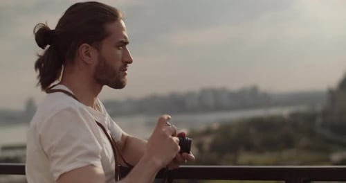 Bearded Man Taking Pictures of City Skyline