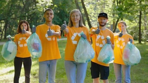 Portrait MultiEthnic Group of EcoActivists Showing Thumbs Up After Cleaning the Forest From Garbage