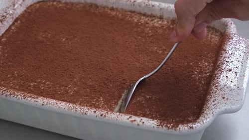 Taking a Portion of Homemade Tiramisu