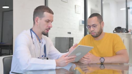 Doctor Explains Diagnosis to Patient with Tablet