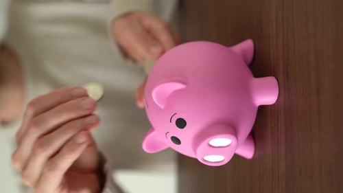 Vertical shot. Concept of savings and keeping money in piggy bank.