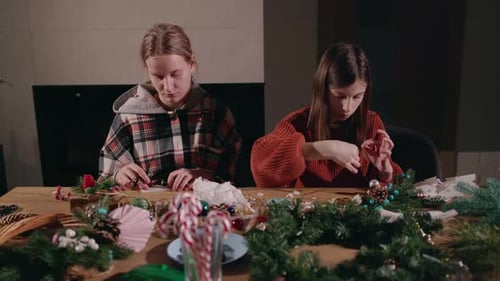 Teen Girls Crafting Christmas Decorations at Table