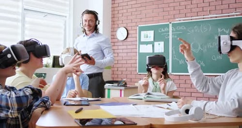 Children Use VR Headsets in Classroom with Teacher