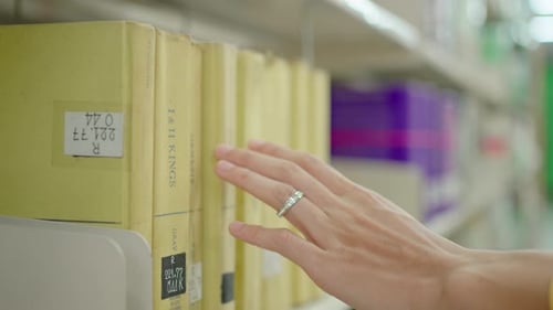 Young University Male Searching For A Book In A Library.