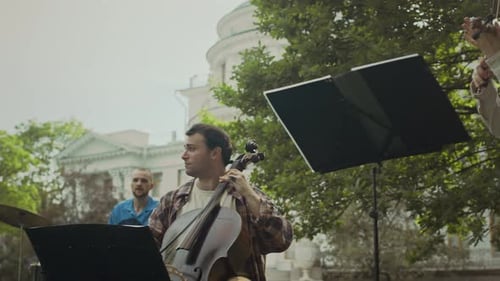 Group of Musicians Playing Classical Instruments on Rehearsal in Park