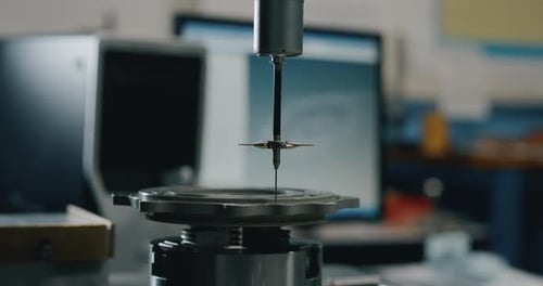 Slow motion macro of specialist is working on production of different gearing details in a worksho