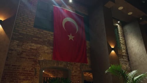 Turkish Flag Hanging Indoors on Rustic Brick Wall