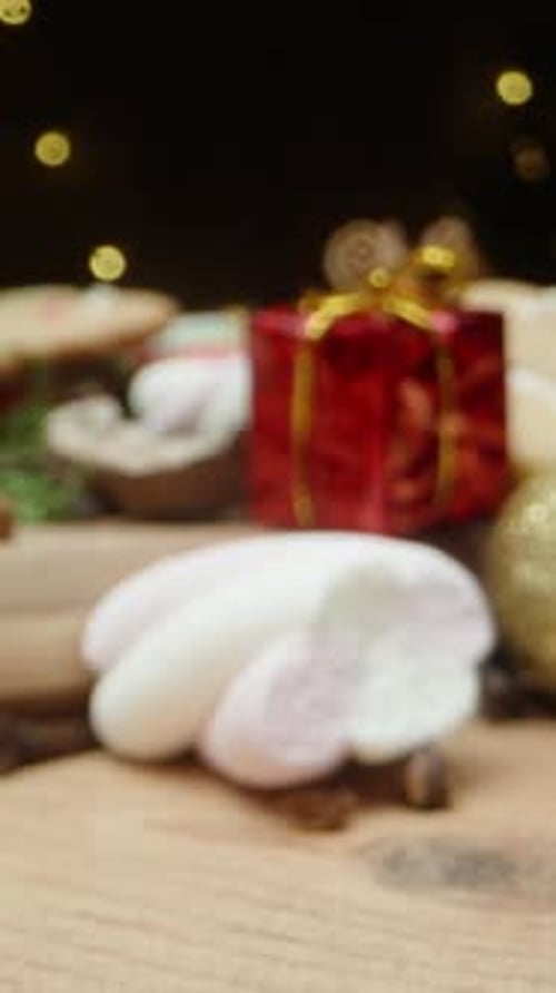 Vertical video. A Christmas table adorned with gingerbread cookies, marshmallows, and cocoa.