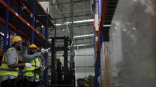 Blue collar workers working at warehouse.