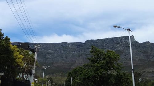 Driving On The Road Looking At Table Mountain Range Through Cape Town, South Africa. POV