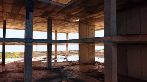Floors of the unfinished structure with some rubbish on. Building construction at the seashore.