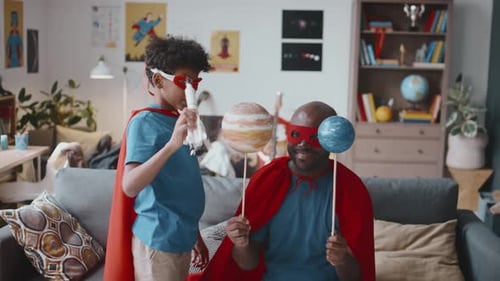 Dad and Son Play Superhero in Living Room