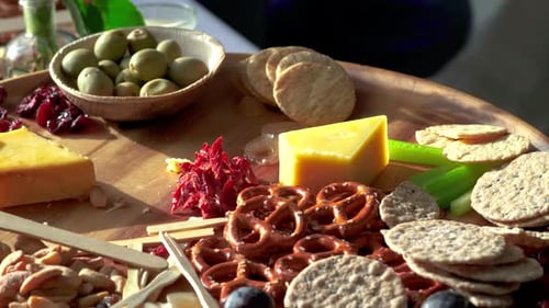 Food being picked off Charcuterie board at event