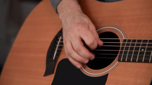 Man Playing Acoustic Guitar Closeup Guitar Deck and Musician's Hand Wooden