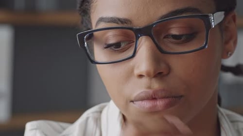 Woman Wearing Glasses Looks Down Then To Side