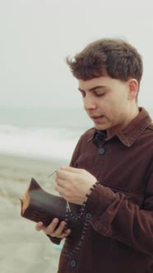 Christian Devoted Man Starting A Prayer On His Knees At The Beach
