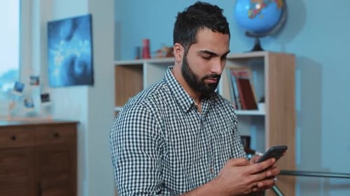 Serious Attractive Young Face Man Use Phone Sit on Sofa Home Smartphone Hands Electronic App Hold
