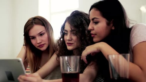 Three Young Women Friends Using Tablet Together
