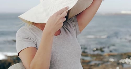 Woman Posing in Hat Laughing at Beach