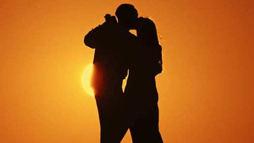 Couple Dancing in Silhouette at Sunset