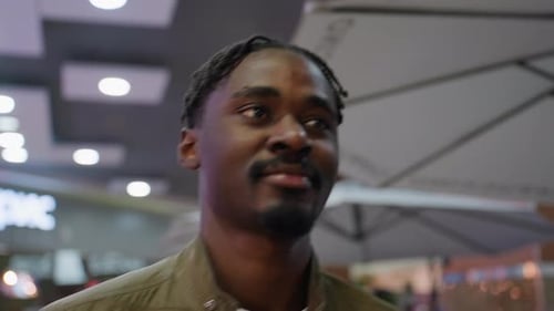 Adult Walking In Cafe With Warm Smile