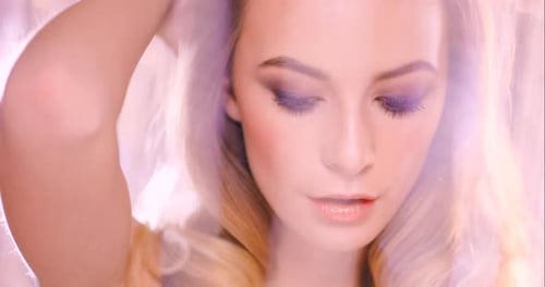 4k video footage of a young woman seductively posing against a studio background