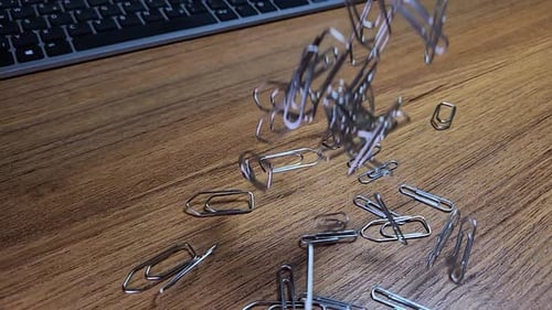 Close Up of Paper Clips Falling Down in Super Slow Motion