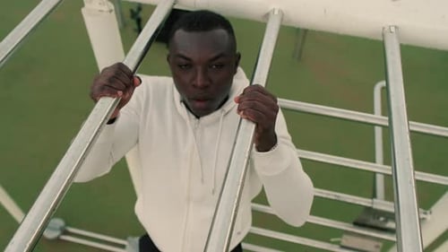 Top view of a man doing pull-ups on a horizontal bar