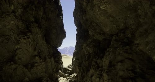 Exploring a Narrow Passage Between Towering Rock Formations Under Clear Skies