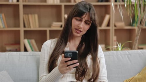 Woman Using Phone in Living Room