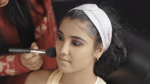 Young Adult Applying Cosmetics with Brush