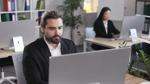 Male Programmer Using Computer in Software Company Office