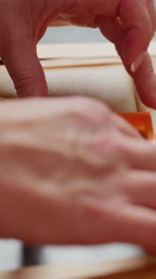 Hands Crafting Dough into Rectangular Shapes on Board