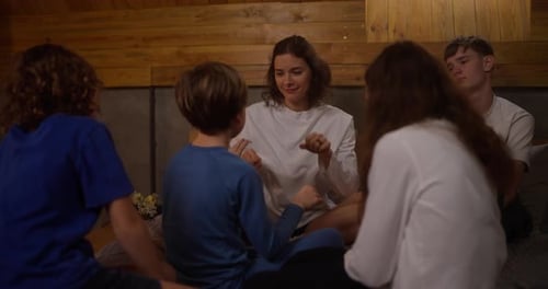 Woman and Children Playing Hand-Clapping Game
