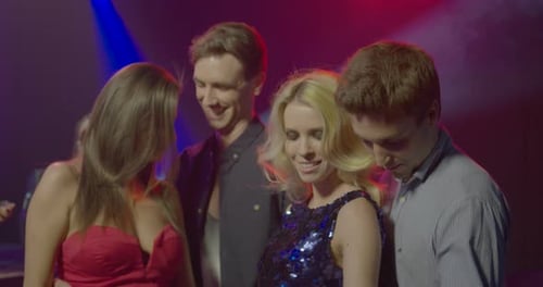 Two Couples Dancing Together in an Urban Nightclub