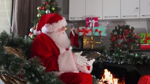Santa Speaks and Gestures Then Continues Browsing His Notes, Holidays ...