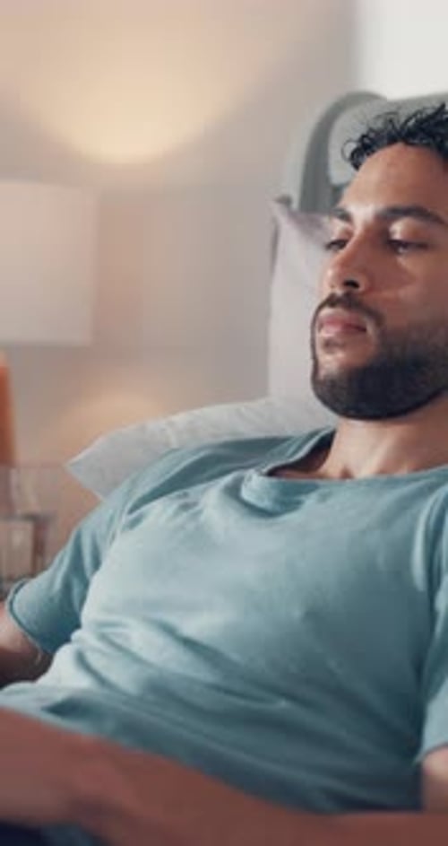 Young Bearded Man Relaxing in Bed at Home
