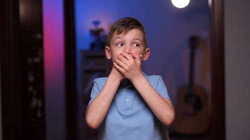 Boy Covering Mouth Indoors at Home