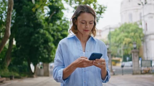 Serious Lady Looking Cellphone Standing in Park Closeup Relaxed Woman Strolling
