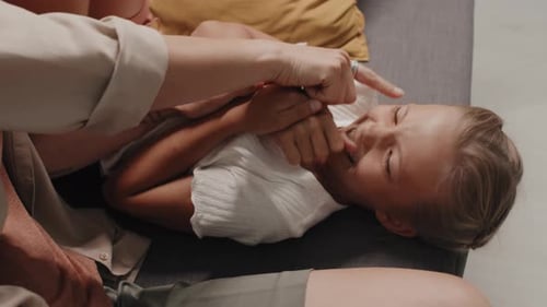 Laughing Child Getting Tickled on Couch