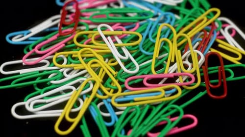 Colorful Metal Paper Clips on a Black Background