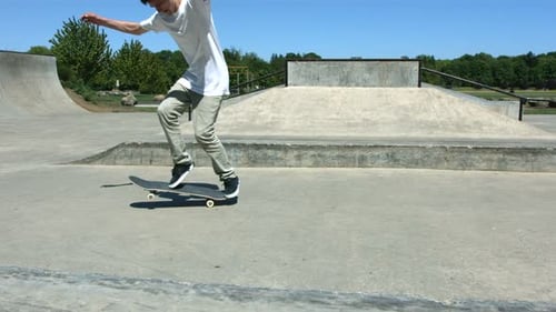 Teen Boy Does Skateboard Tricks at Skate Park
