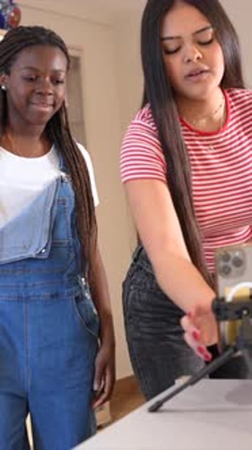 Teen friends creating content with smartphone and microphone