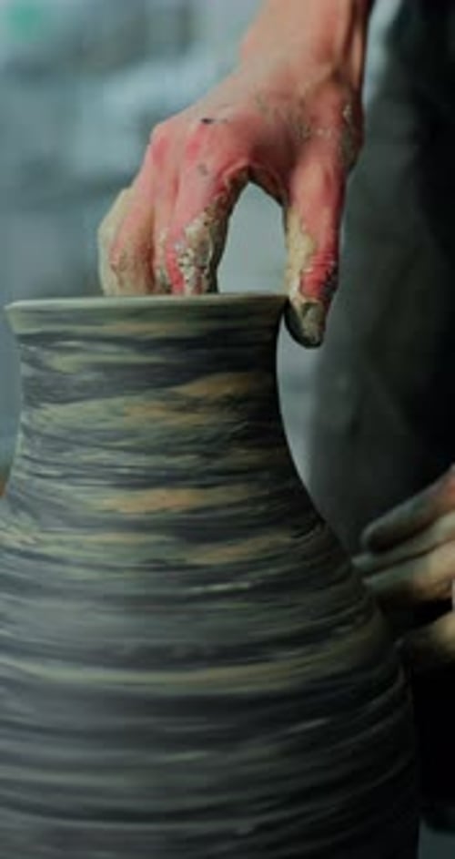 Artisan Shaping Clay Pottery Vase on Wheel