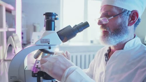 Scientist Using Microscope in Bright Laboratory