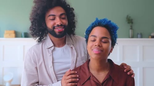 Smiling Young Couple Poses Indoors Affectionately