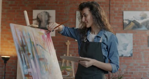 Creative Young Lady Painting on Canvas Enjoying Artistic Work Preparing for Exhibition in Studio