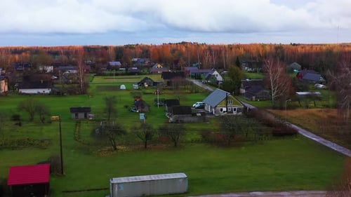 Aerial view of vibrant village surrounded by fields and autumn hues