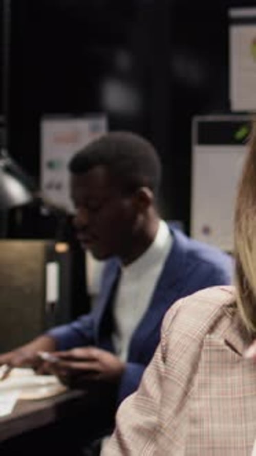 Office Workers Discussing Business Documents in Office