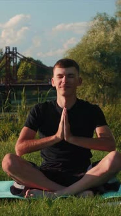 Man Practicing Yoga Outdoors on a Sunny Day